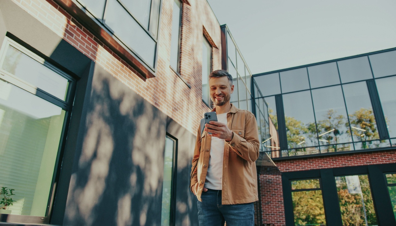 man outside looking at phone