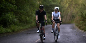 man and woman road cycling