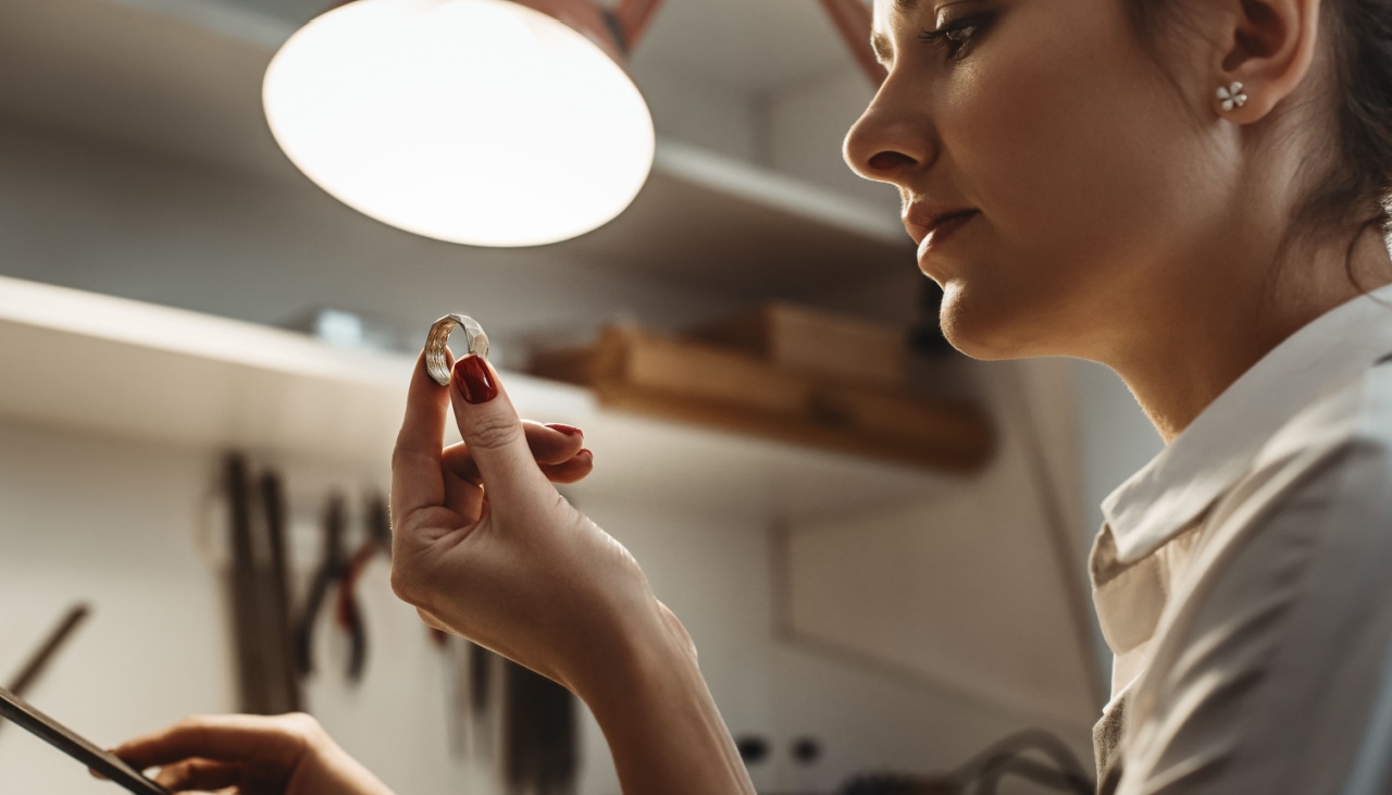 young female jeweler inspecting a ring