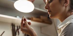 young female jeweler inspecting a ring