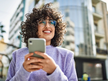 smiling young woman on phone