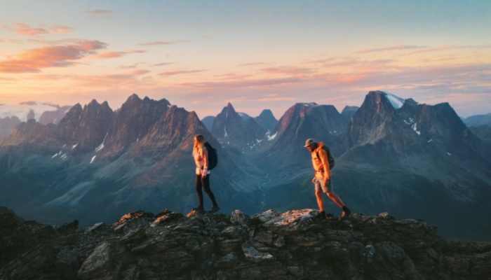 man and woman hiking on mountain range