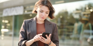 young business woman typing on her phone