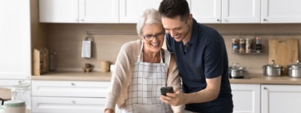 Grown up son spend time with mother in kitchen