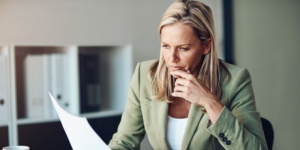 business woman doing paperwork at her desk