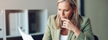 business woman doing paperwork at her desk