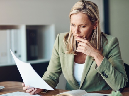 business woman doing paperwork at her desk