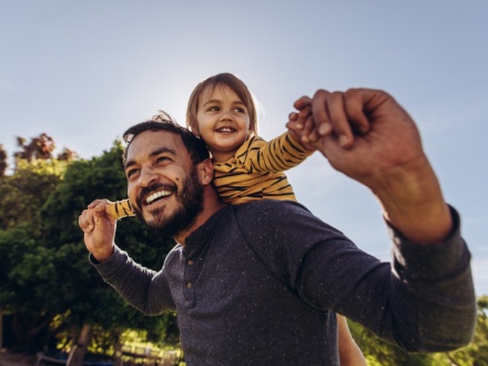 father with child on his shoulders