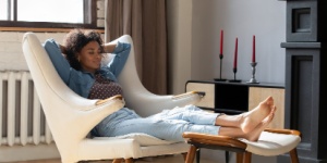 African woman at home relaxing in chair