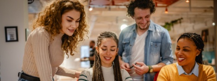 group of young people working in an office
