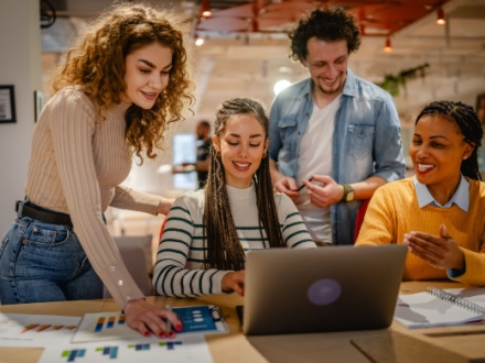 group of young people working in an office