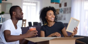 Man and woman unpacking boxes in new home