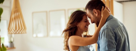 happy couple at home hugging