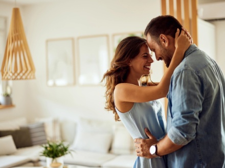 happy couple at home hugging