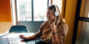 smiling woman in office with headphones