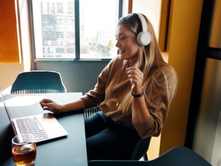 smiling woman in office with headphones