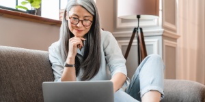 Woman with glasses looking at lapto