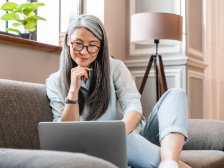 Woman with glasses looking at laptop
