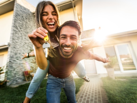 happy young couple holding home keys