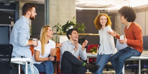 Group of happy office workers have coffee break together