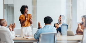 Group of diverse office workers clapping hands in a meeting