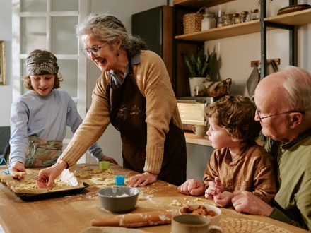 Grandparents cooking at home with grandchildren