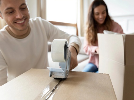 couple packing boxes to move house