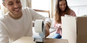 couple packing boxes to move house