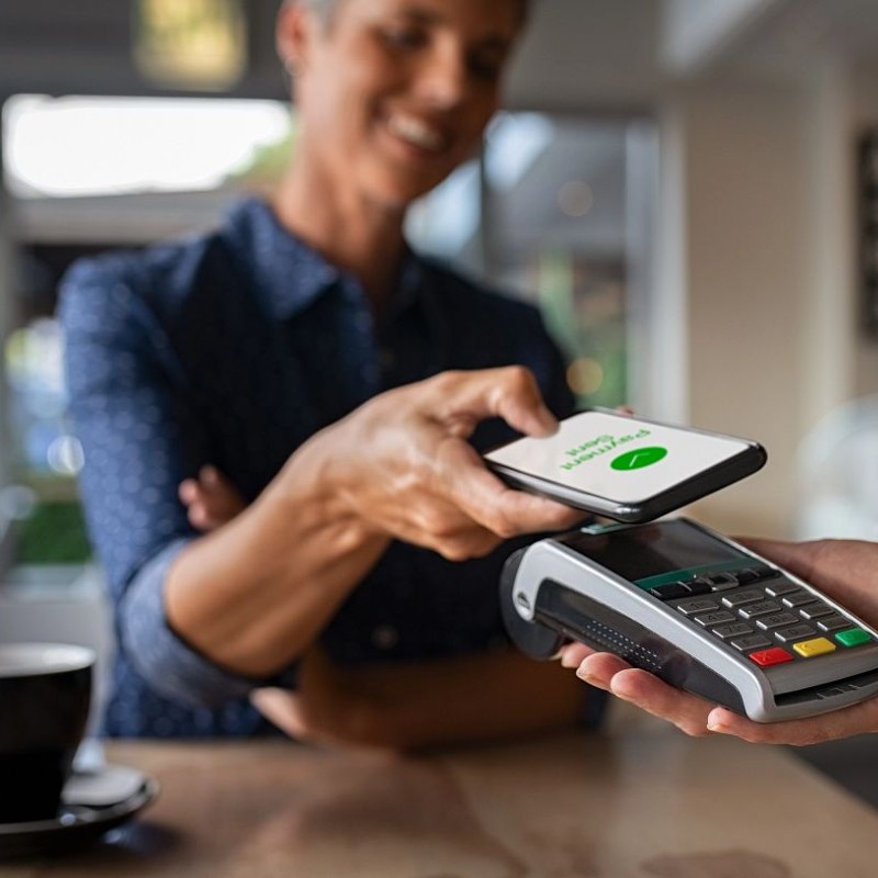 Woman paying for goods using mobile device