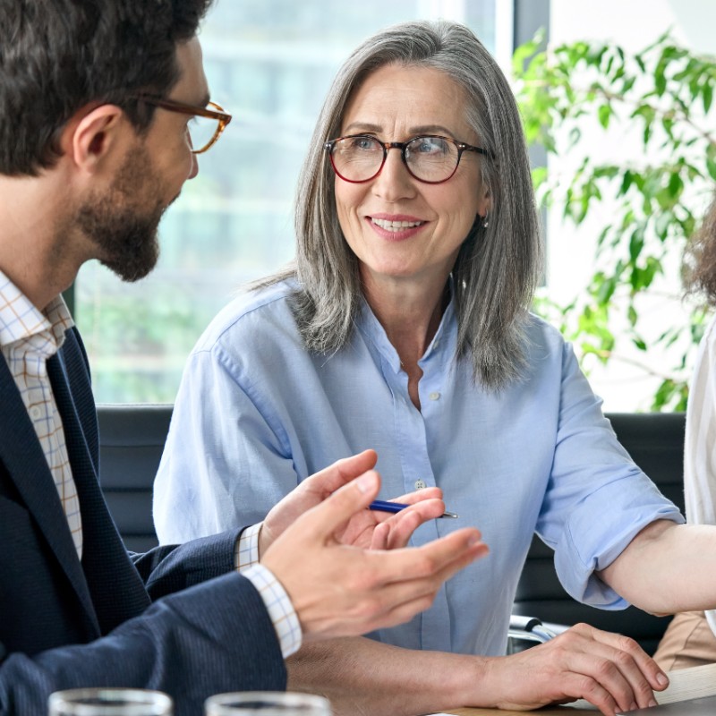 female office worker talking to male office worker