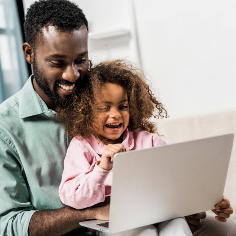 father and daugther on laptop