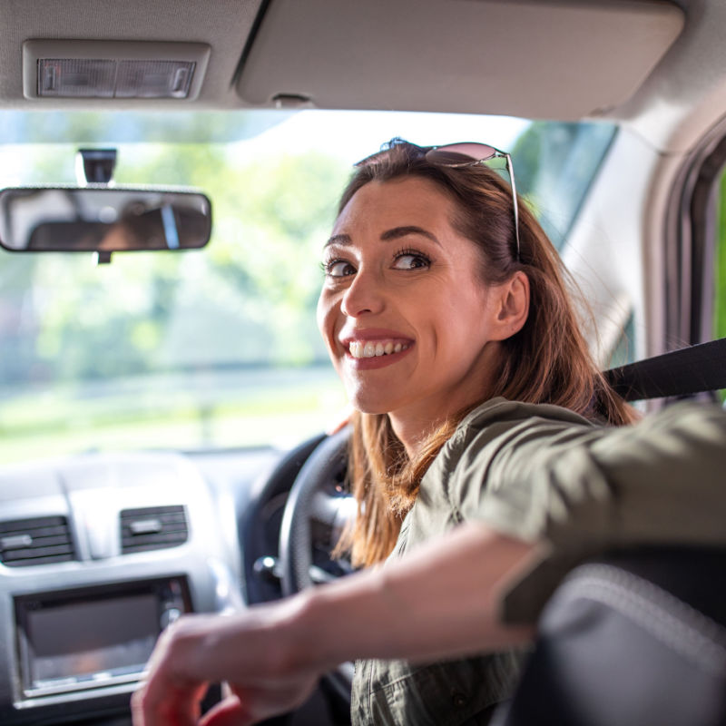 woman looking back in car