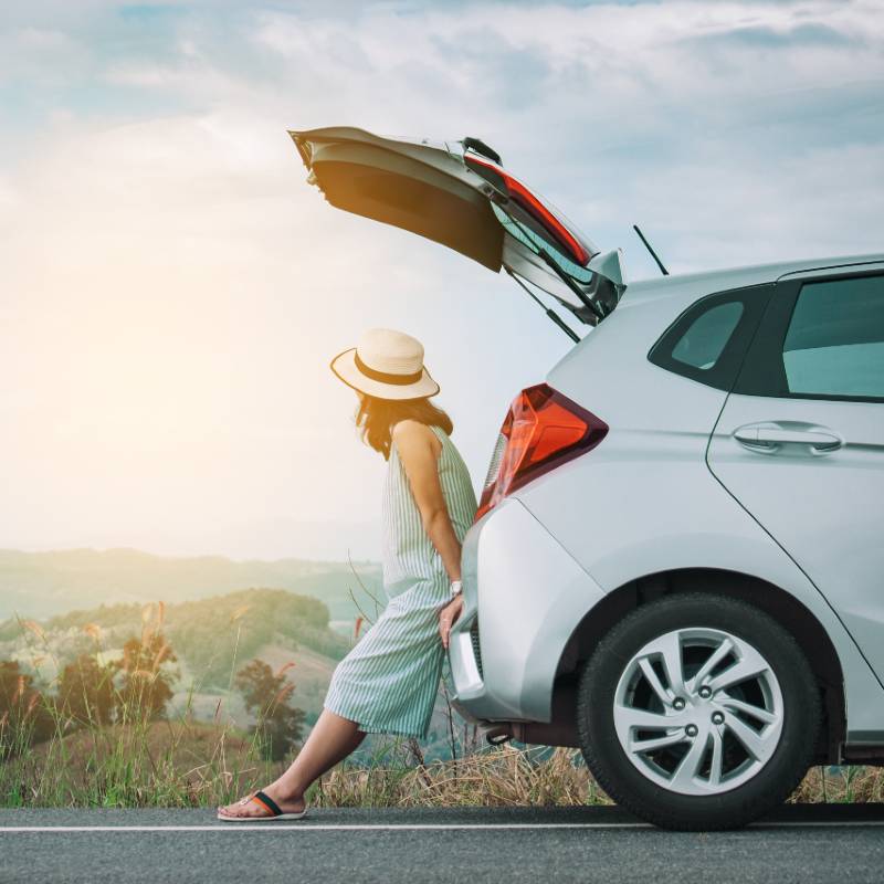 woman sitting at back of car