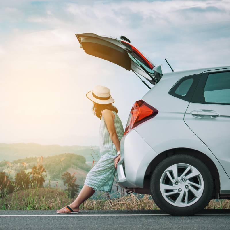 woman sitting at back of car