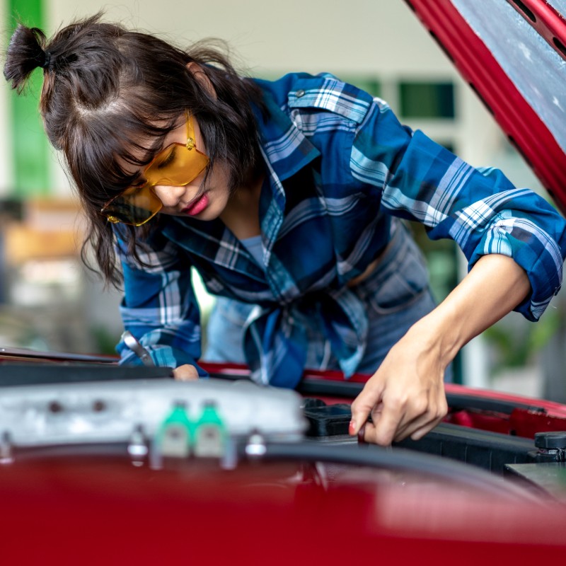 woman fixing car
