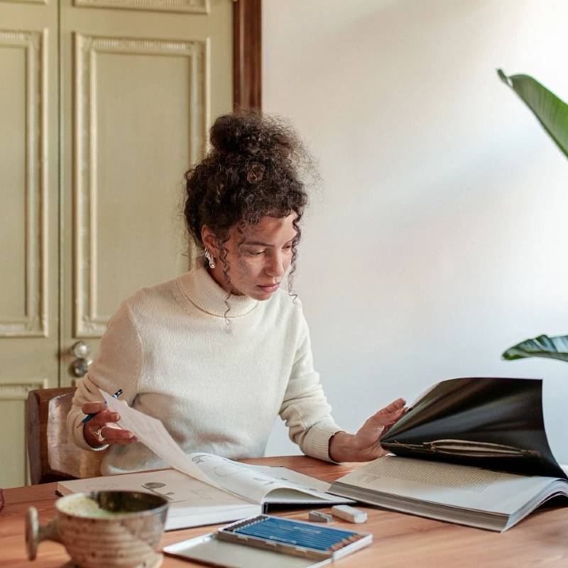 Woman taking notes at table