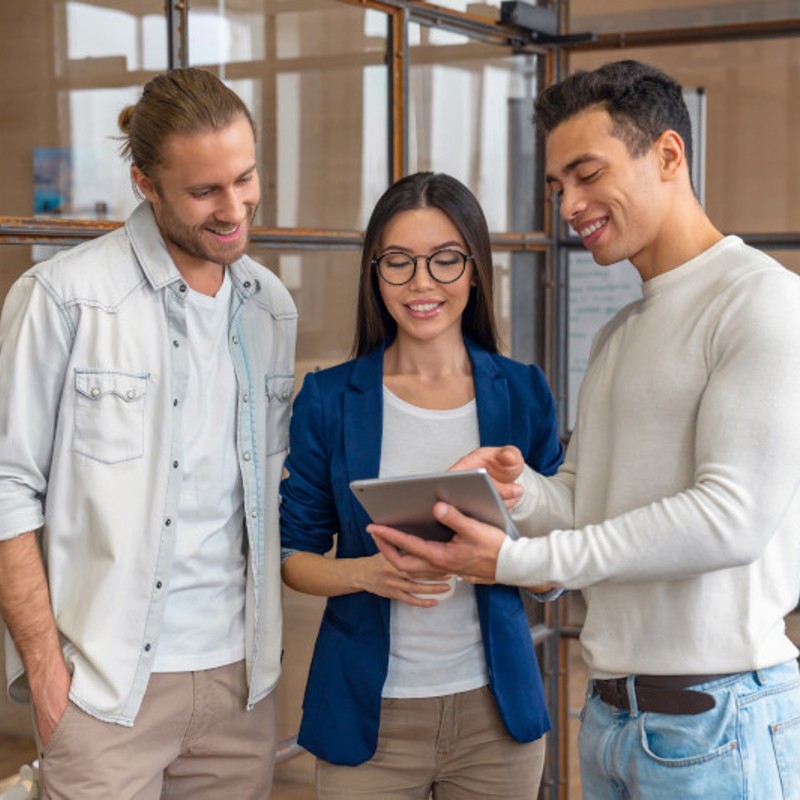 three young office workers on tablet