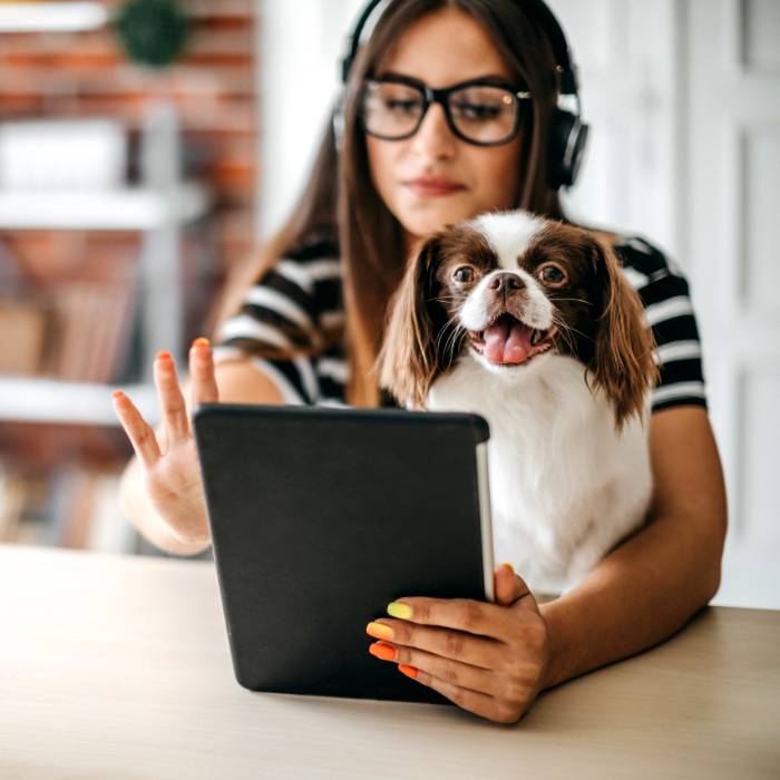 woman at desk with pet dog