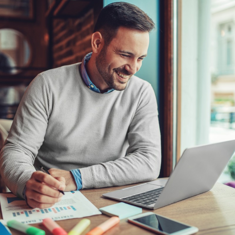 man in coffee shop on laptop