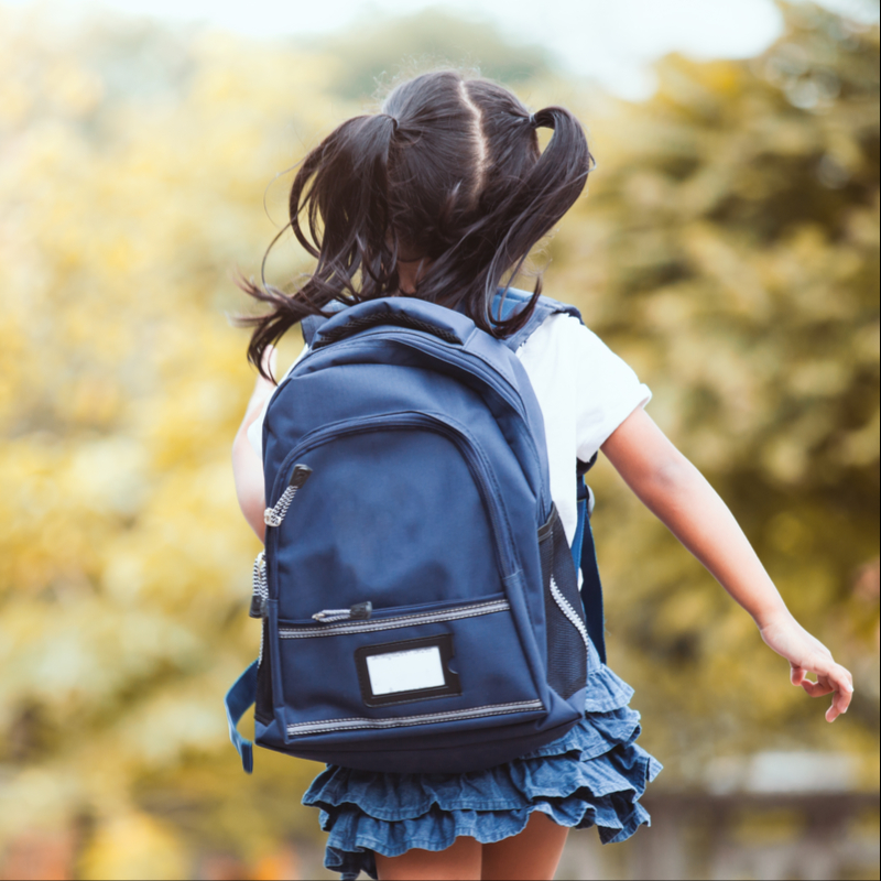 Child running with backpack