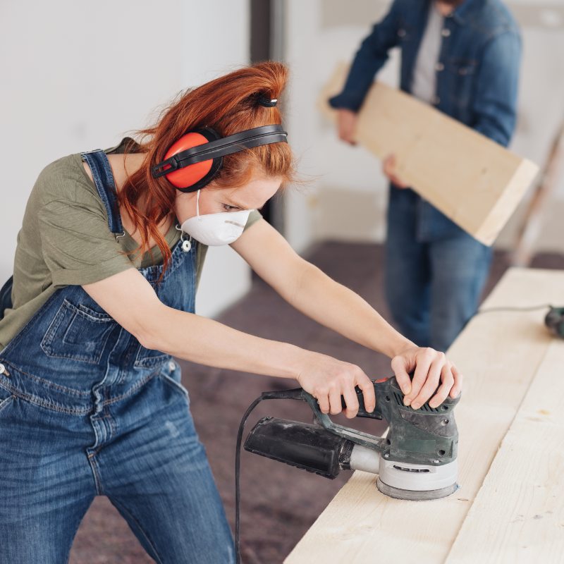 Woman cutting wood