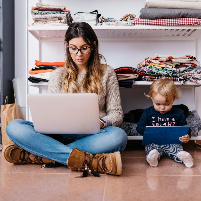 Man and child looking at their laptops