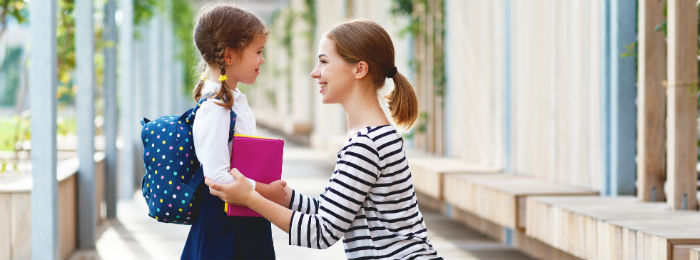 mother and daughter on girls first day of school