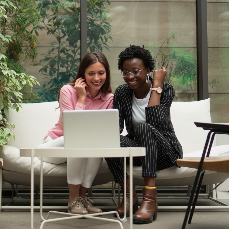 two office workers in green office