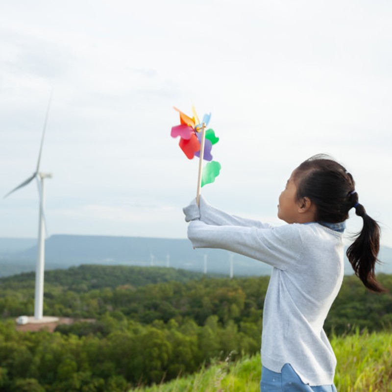 Asian child with hand windmill